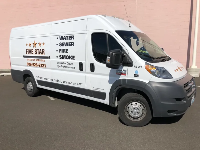 Five Star Disaster Services van lettered with Water, Sewer, Fire, Smoke and the phone number (509) 525-2121